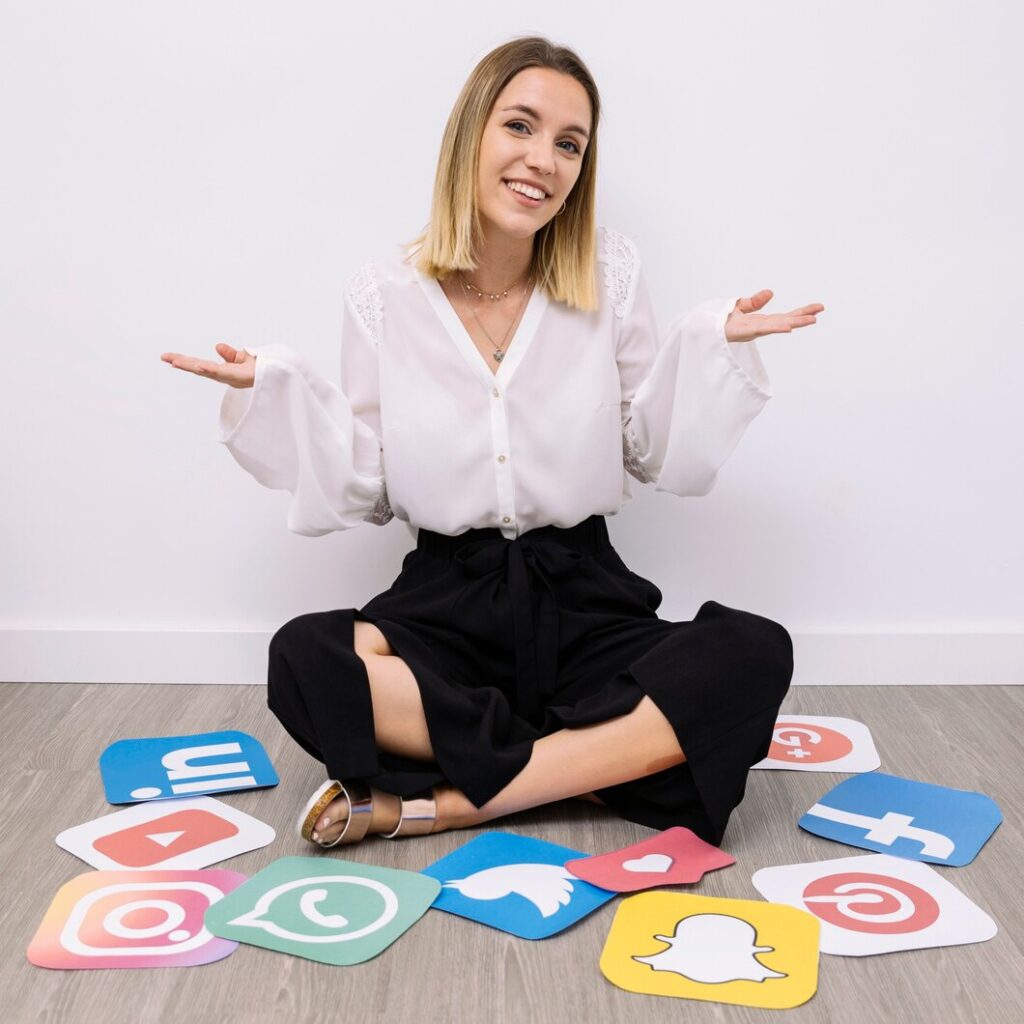 businesswoman sitting floor with social media icons shrugging 23 2147847535 SEO, PPC & Social Media Marketing Services